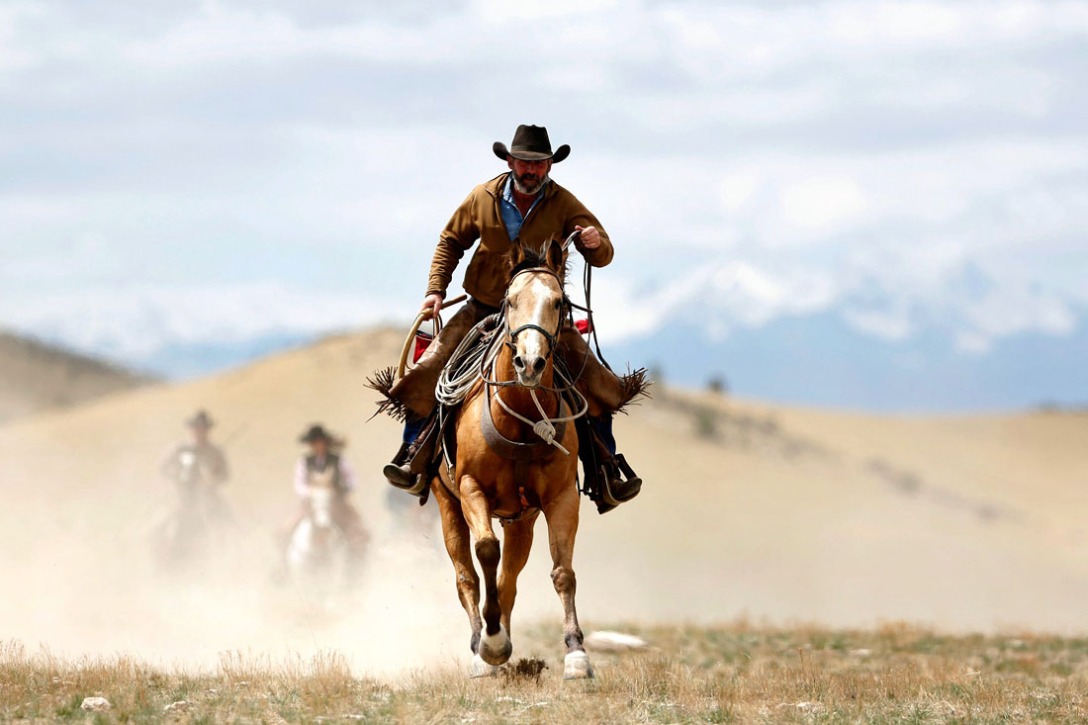 A cowboy and his horse kick up dust out on the range. Photo Credit: PictureNix.com.